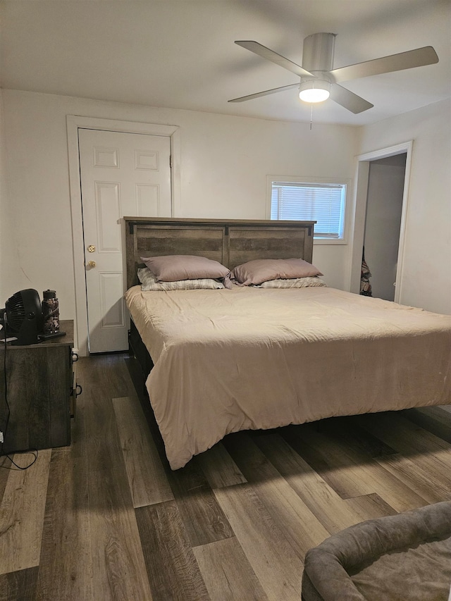 bedroom with ceiling fan and dark hardwood / wood-style floors