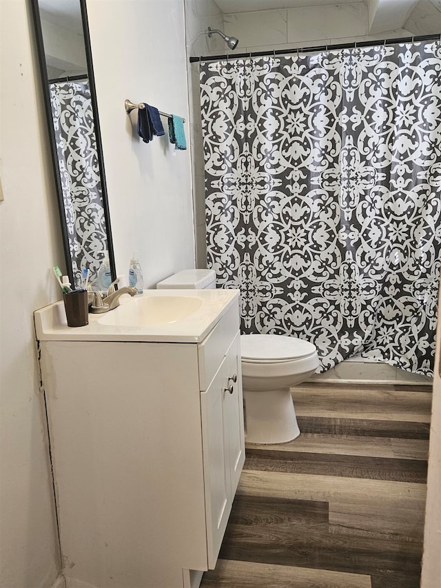 bathroom with vanity, toilet, hardwood / wood-style floors, and a shower with shower curtain