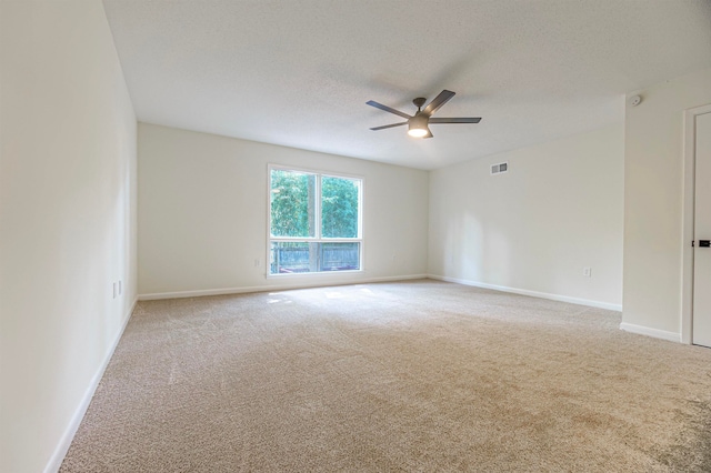 carpeted empty room featuring a textured ceiling and ceiling fan