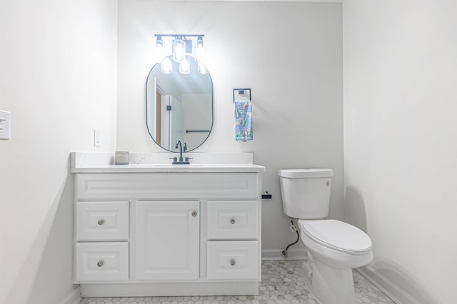 bathroom with tile patterned flooring, vanity, and toilet