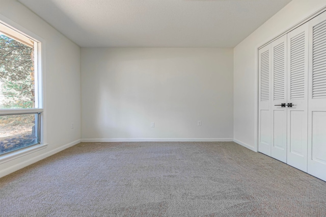 unfurnished bedroom featuring a closet and carpet