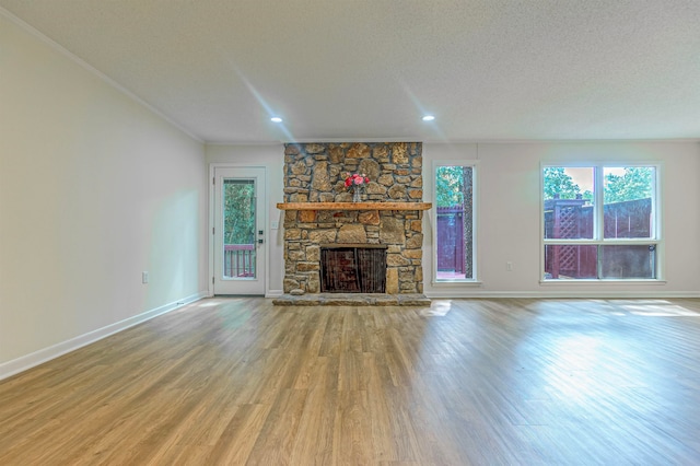 unfurnished living room featuring a fireplace, a textured ceiling, and hardwood / wood-style floors