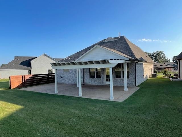 back of property featuring a yard and a patio