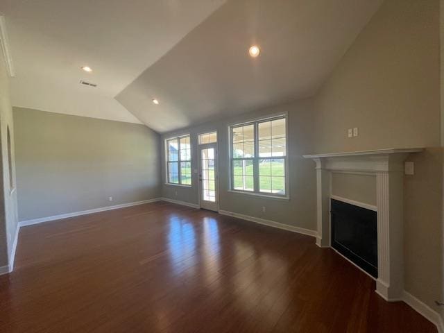 unfurnished living room featuring vaulted ceiling and dark hardwood / wood-style floors