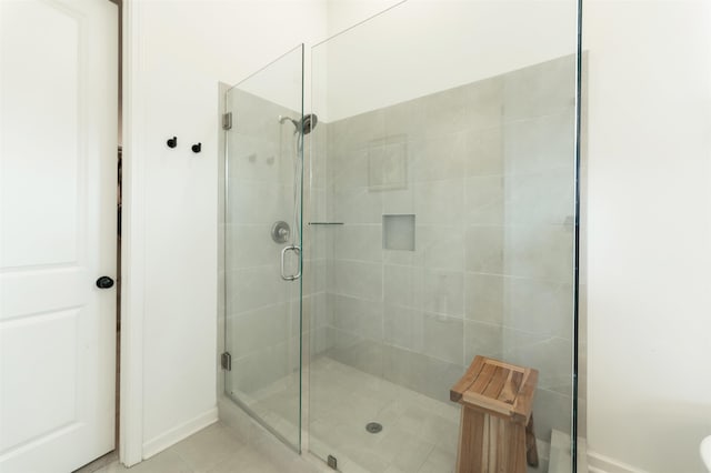 bathroom with tile patterned flooring and an enclosed shower