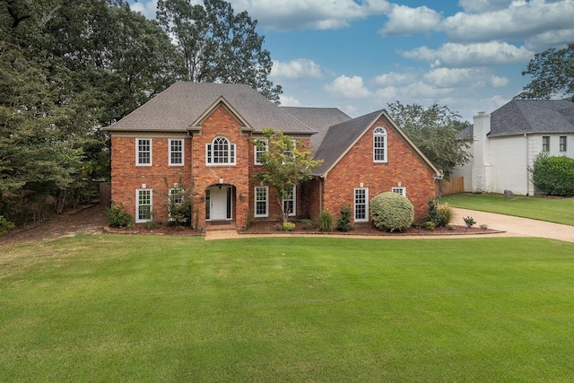 colonial-style house with a front yard