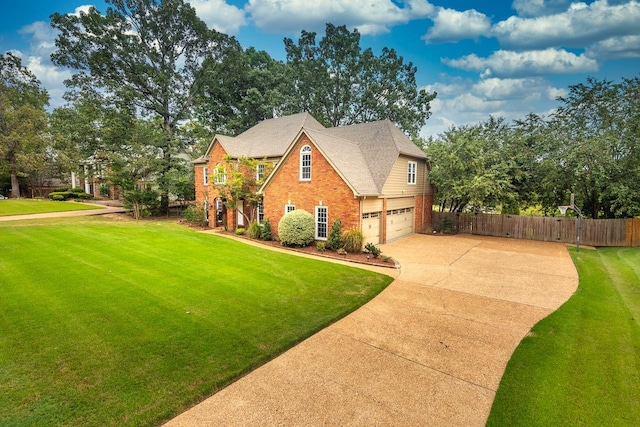 view of front of house with a front yard and a garage