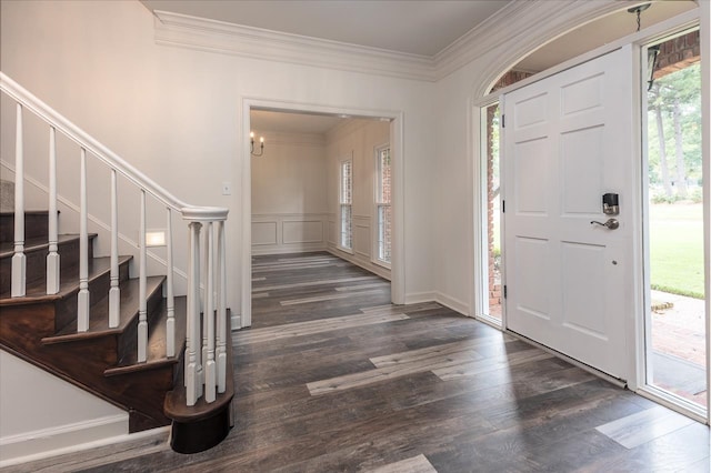 entrance foyer featuring crown molding and dark wood-type flooring