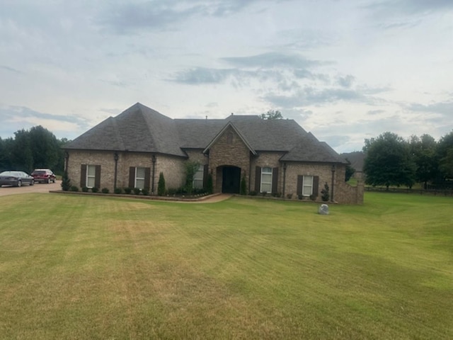 french country style house featuring a front yard