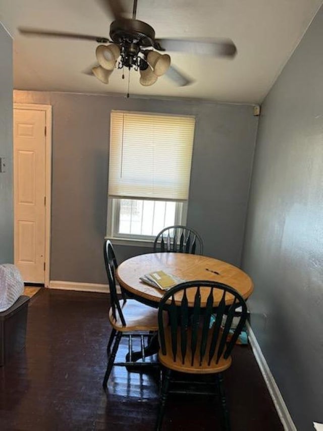 dining room with ceiling fan and hardwood / wood-style flooring