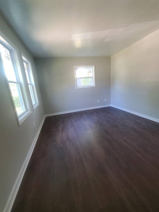 empty room with dark wood-type flooring