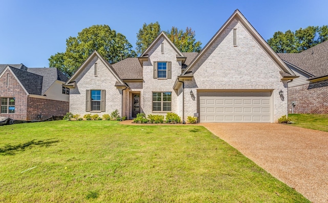 view of front of home with a garage and a front lawn