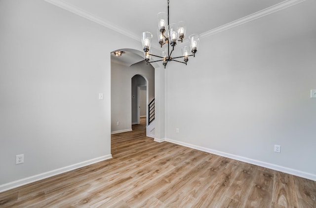 unfurnished dining area featuring ornamental molding, light hardwood / wood-style flooring, and a notable chandelier