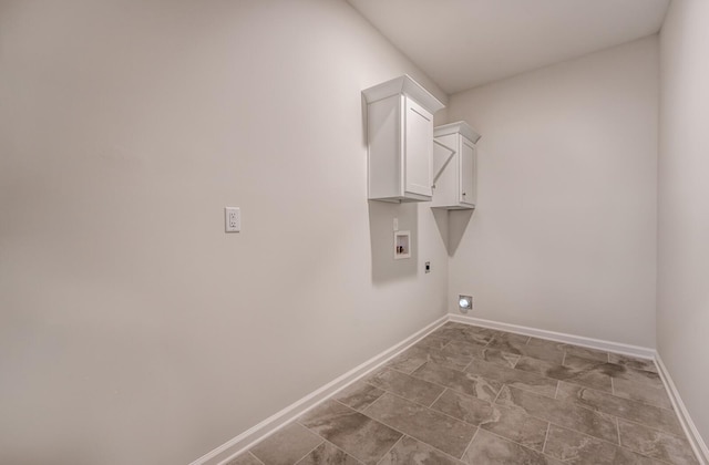 clothes washing area with hookup for a washing machine, cabinet space, baseboards, and electric dryer hookup