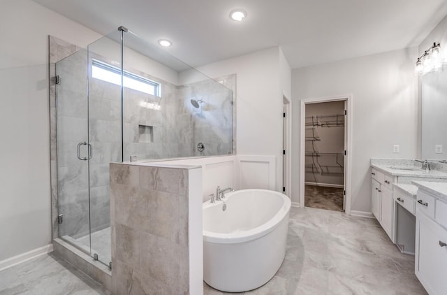 full bathroom featuring a spacious closet, marble finish floor, a stall shower, and a freestanding bath