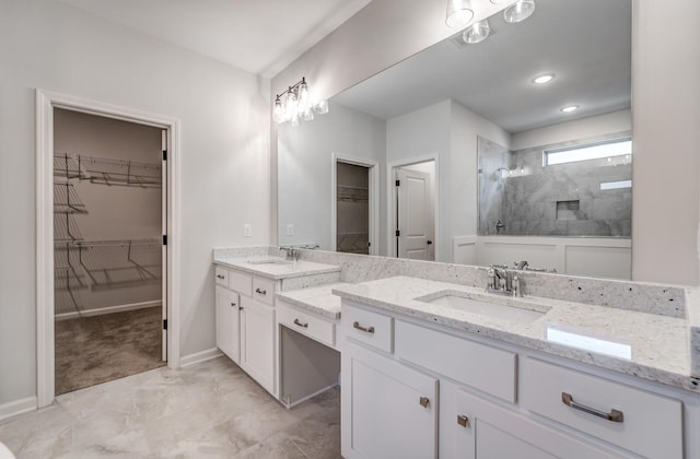 full bathroom featuring marble finish floor, a walk in shower, recessed lighting, baseboards, and vanity