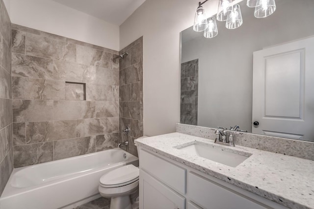 bathroom featuring vanity, toilet, and shower / bathing tub combination