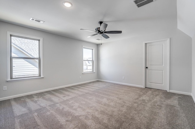 carpeted empty room featuring ceiling fan