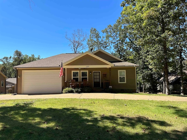 view of front of house with a garage, covered porch, and a front lawn