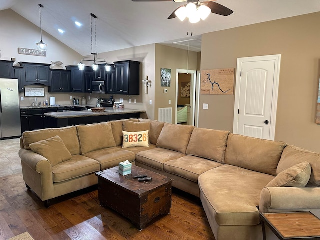 living room with high vaulted ceiling, ceiling fan, dark hardwood / wood-style flooring, and sink