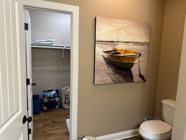 bathroom featuring toilet and hardwood / wood-style flooring