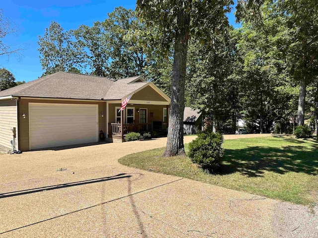 view of front of home featuring a garage, a porch, and a front lawn