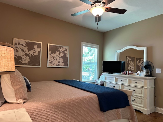 bedroom with ceiling fan and wood-type flooring