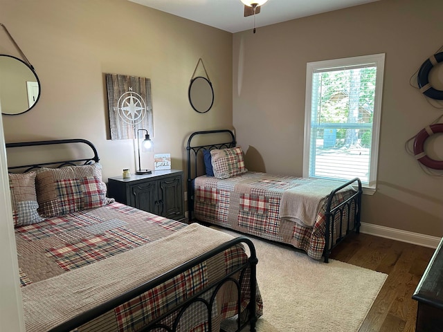 bedroom with ceiling fan and dark hardwood / wood-style floors