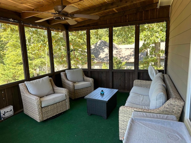 unfurnished sunroom with wood ceiling, beamed ceiling, and ceiling fan