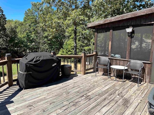 wooden terrace with a grill