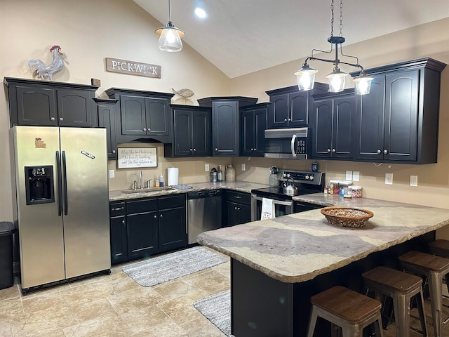 kitchen with a kitchen bar, pendant lighting, sink, and appliances with stainless steel finishes