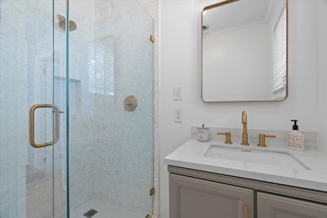 bathroom featuring a shower with door and vanity