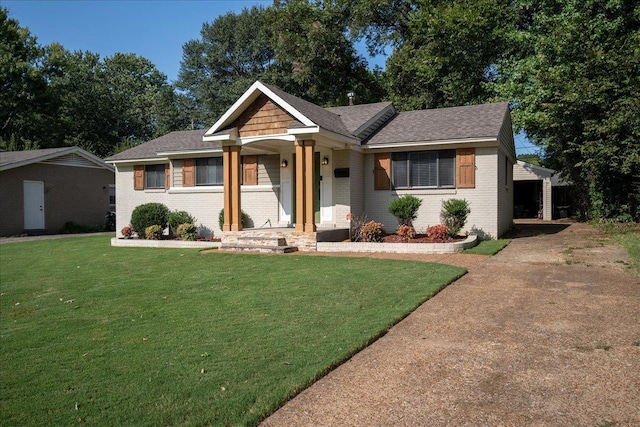 view of front of property featuring brick siding, concrete driveway, and a front lawn