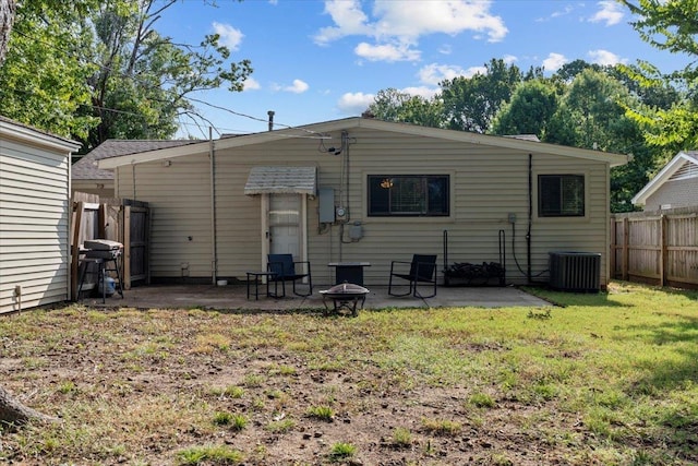 back of house featuring a yard, central AC, a patio, and fence