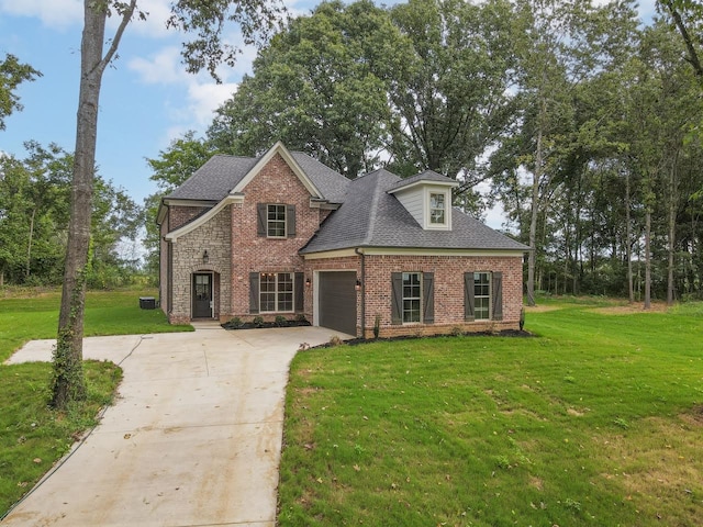 view of front of home with a garage and a front yard