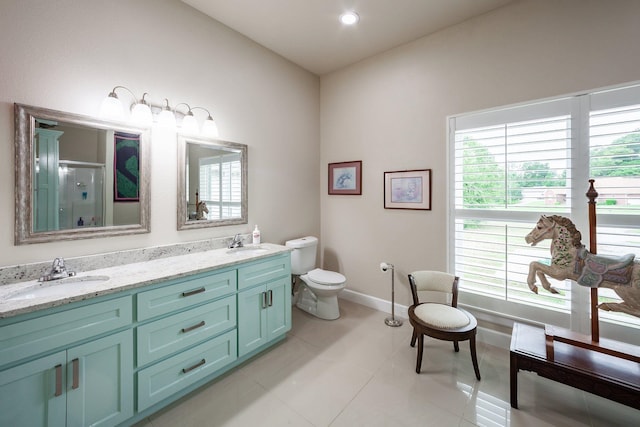 bathroom featuring vanity, toilet, walk in shower, and tile patterned floors