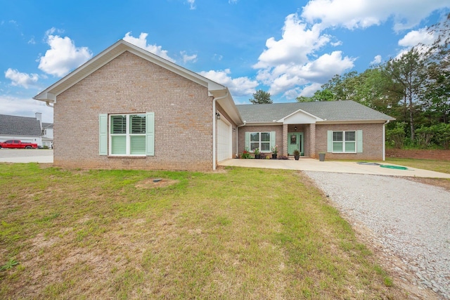 view of front of home featuring a garage and a front lawn