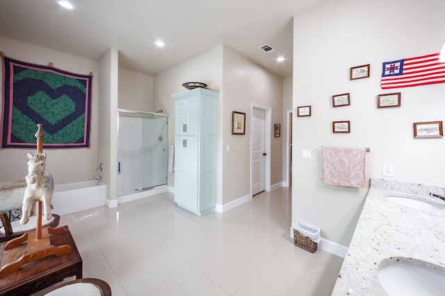 bathroom featuring independent shower and bath, vanity, and tile patterned floors