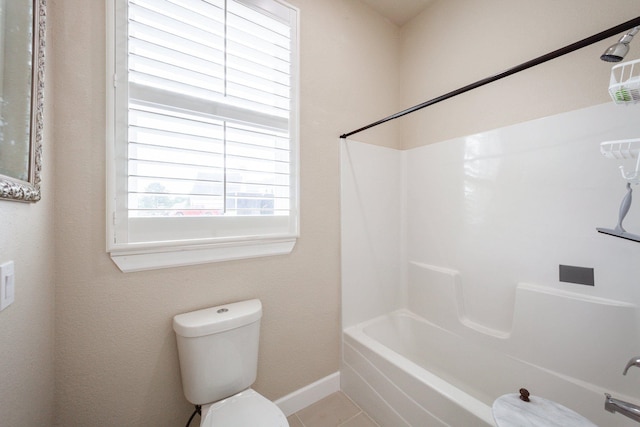 bathroom featuring tile patterned flooring, toilet, and shower / bathing tub combination