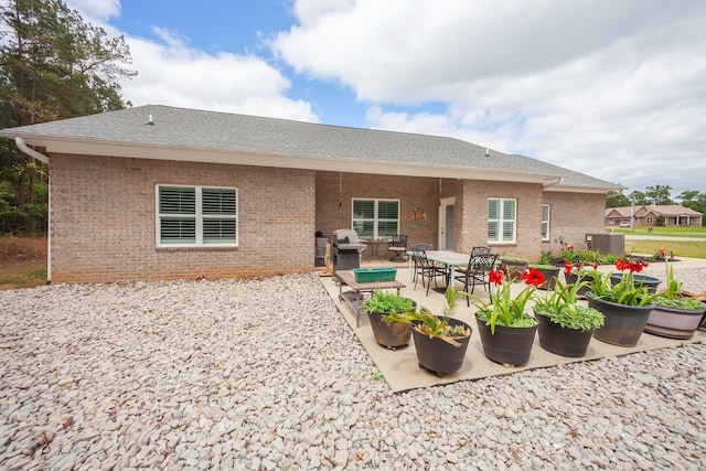 back of property featuring central AC and a patio