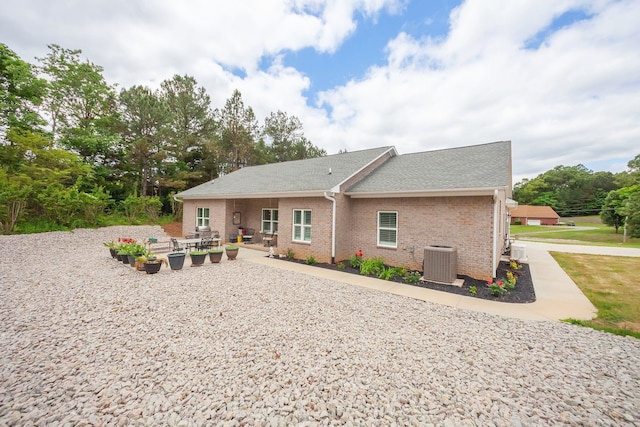 rear view of property featuring a patio area and central air condition unit