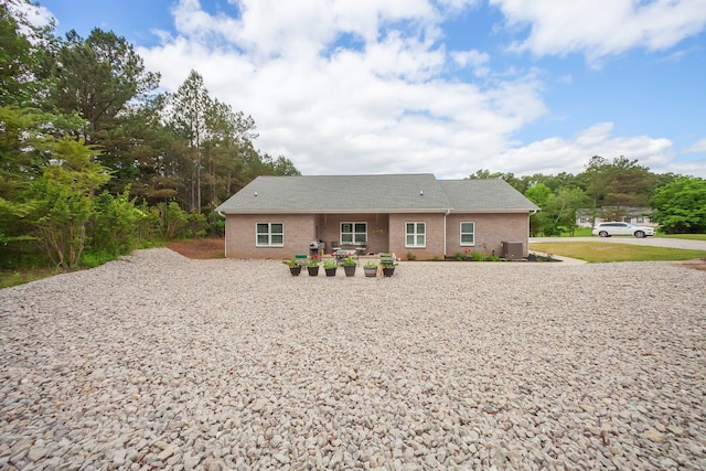 ranch-style home featuring central AC unit and a patio area