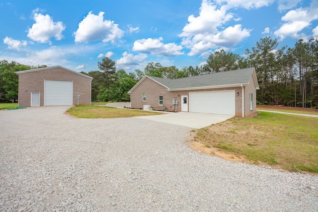 ranch-style home featuring a garage and a front lawn