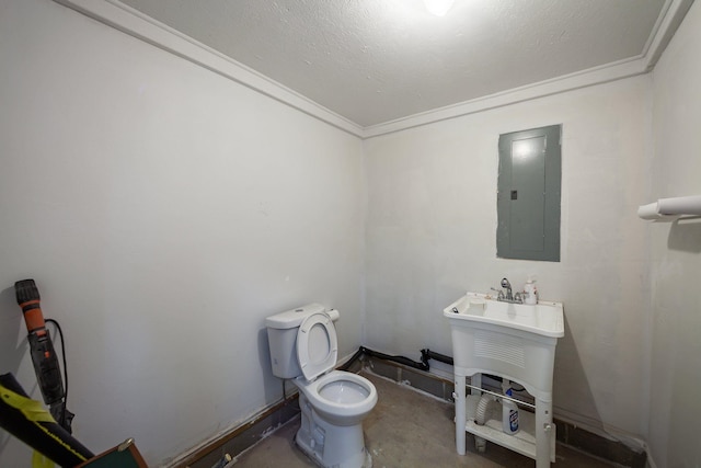 bathroom featuring electric panel, toilet, ornamental molding, and concrete floors