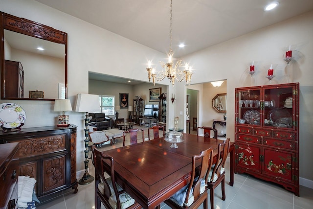 dining room with a chandelier and light tile patterned floors