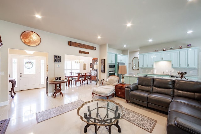 living room with an inviting chandelier and light tile patterned flooring