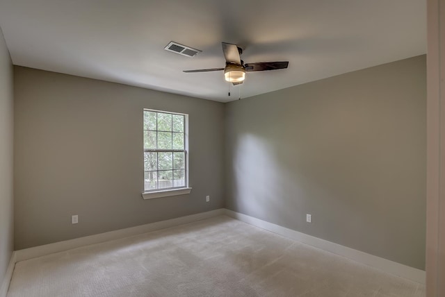 spare room featuring light carpet and ceiling fan