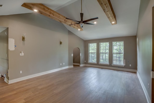 spare room with ceiling fan, high vaulted ceiling, beam ceiling, and light hardwood / wood-style floors