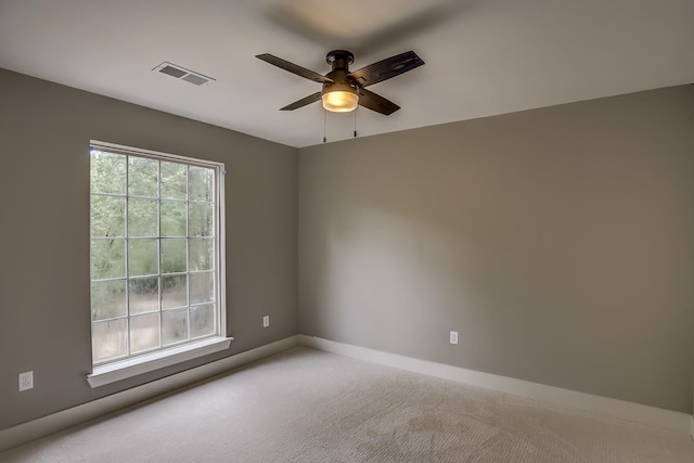 carpeted empty room featuring ceiling fan