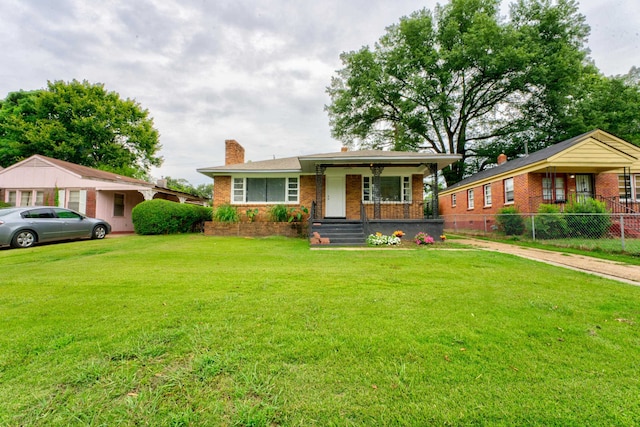 single story home with covered porch and a front lawn